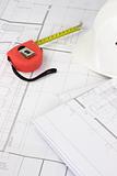 Red measuring tape on construction plans