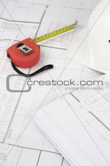 Red measuring tape on construction plans