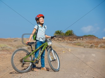 Teenager girl over a bicycle and looking the view