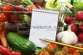 shopping list with basket and fresh vegetables