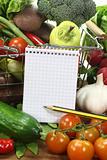 shopping list with pencil, basket and vegetables
