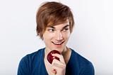 Young man eating a apple