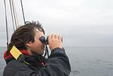 Sailor looking in binoculars