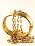 gold jewelry, bracelets and chains on a white background