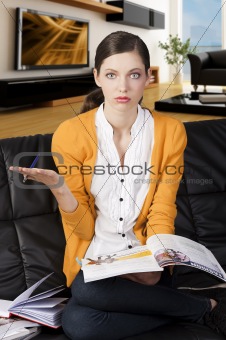 the girl reading a book, her right hand is open and she has expr
