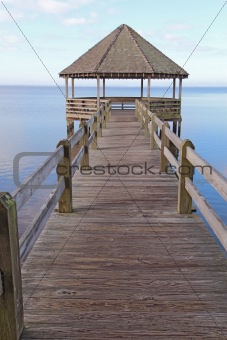 Gazebo and dock over calm sound waters vertical