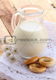 jug with milk  on a wooden table , rustic style