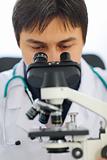 Closeup on medical doctor looking in microscope