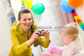 Mother making photos of babys first birthday