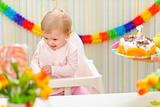 Baby happy and embarrassed receiving birthday cake
