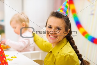 Portrait of happy mother celebrating baby first birthday