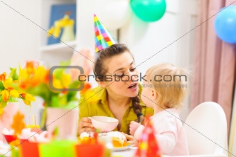 Mother celebrating first birthday of her baby