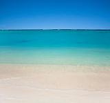 beach with clear  waters and blue sky