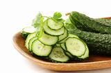 cut into slices of cucumber on white background