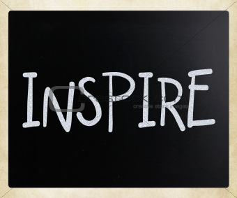 "Inspire" handwritten with white chalk on a blackboard