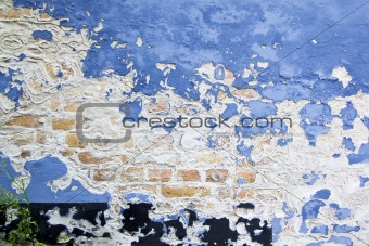 blue paint peeling brick wall