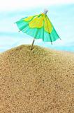 cocktail umbrella on sand