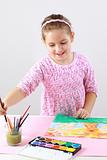 Cute girl painting with watercolor