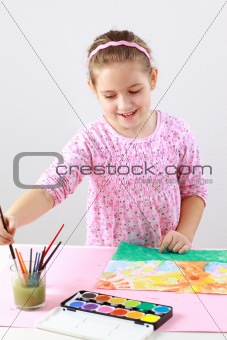 Cute girl painting with watercolor