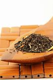 fragrant black tea in wooden spoon
