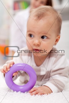 Baby girl with plastic toy
