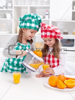 Girls making freshly squezed orange juice