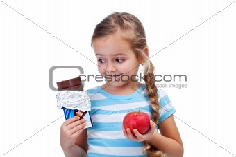 Diet choices - little girl with apple and chocolate