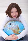 Young girl hugging earth globe