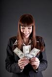Laughing business woman with dollars 