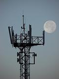 Cell tower at dawn with the moon