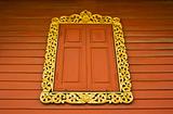 Ancient Golden carving wooden window of Thai temple in Bangkok, Thailand