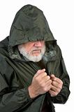 pathetic senior bearded man in green waterproof jacket