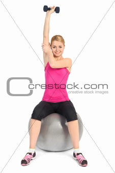 Young woman doing Seated Dumbbell One Arm Triceps Extensions on Fitnes Ball, phase 2 of 2.