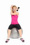 Young woman doing Seated Dumbbell One Arm Triceps Extensions on Fitnes Ball, phase 1 of 2.
