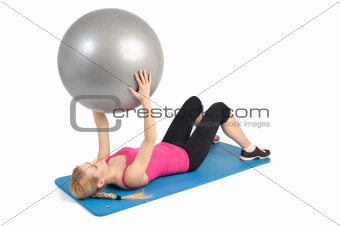 Young blond girl doing kneeling butt blaster exercise using rubber resistance band. position 2 of 2.