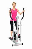 young woman doing exercises with elliptical trainer, on white background