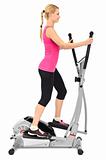 young woman doing exercises with elliptical trainer, on white background