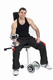 young man posing with dumbbells sitting on bench, on white background