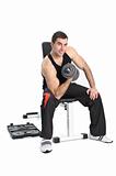 young man posing with dumbbell sitting on bench, on white background