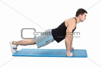 young man performing push-ups exercise on fists, on white background