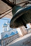 Giant bell with church on background