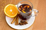 Christmas hot wine with oranges on wooden table