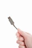 Hand holding grey USB cable 