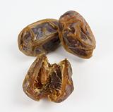 Dates sliced and whole on white background