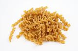 Whole-grain, spiral-shaped noodles on white background