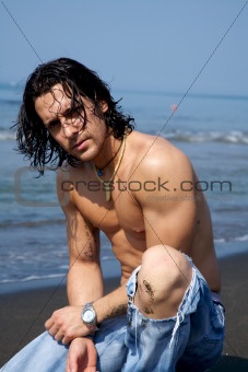 Muscular male model on the beach