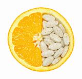 Close up of orange and pills isolated - vitamin concept