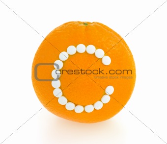 Orange with vitamin c pills over white background - concept