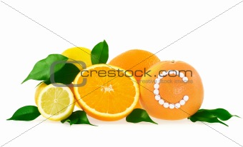 Orange, lemon, grapefruit with vitamin c pills over white background