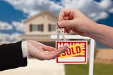 Handing Over the House Keys in Front of Real Estate Sign and Sold New Home.